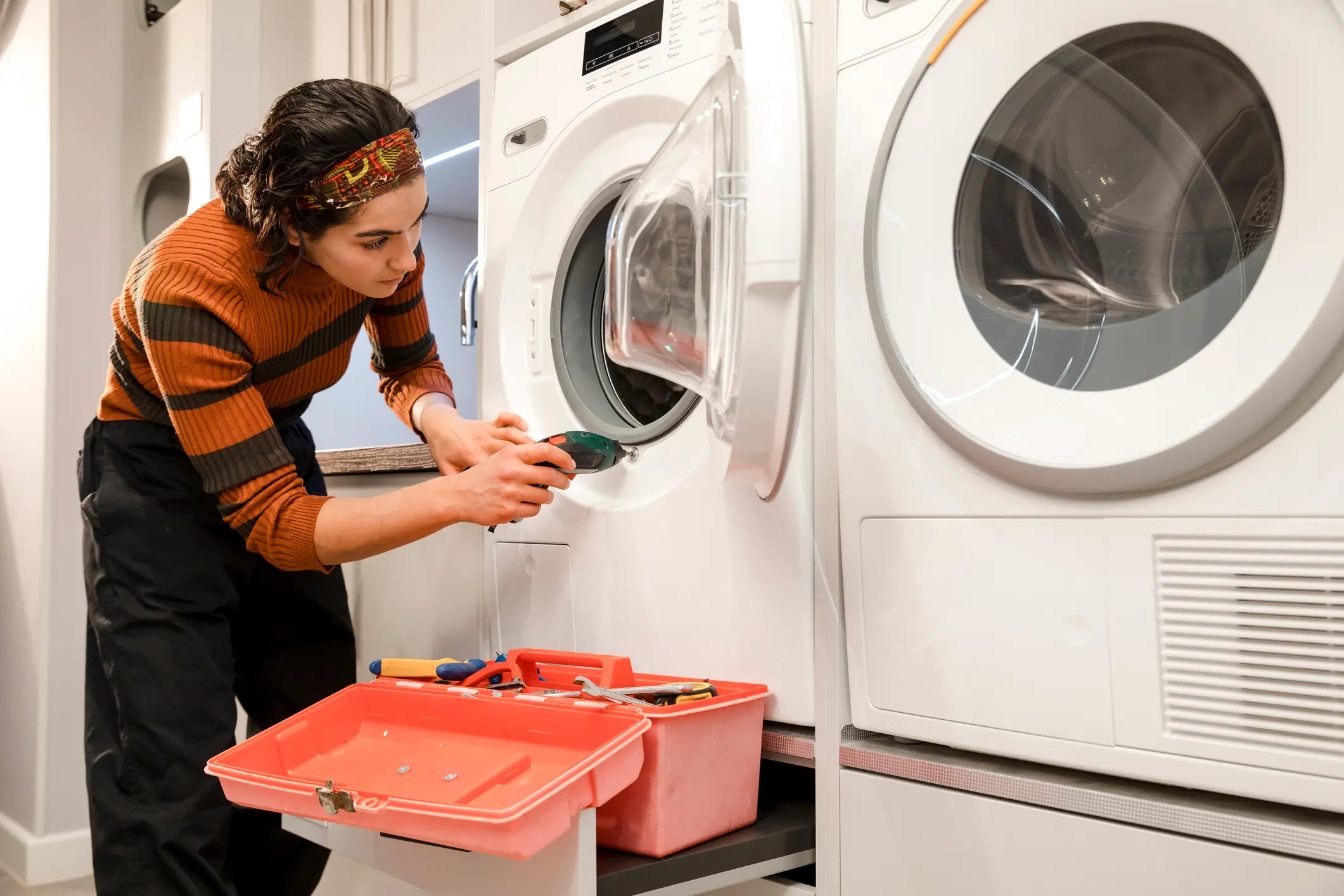 Washing machine being repaired at a customer home in Mumbai